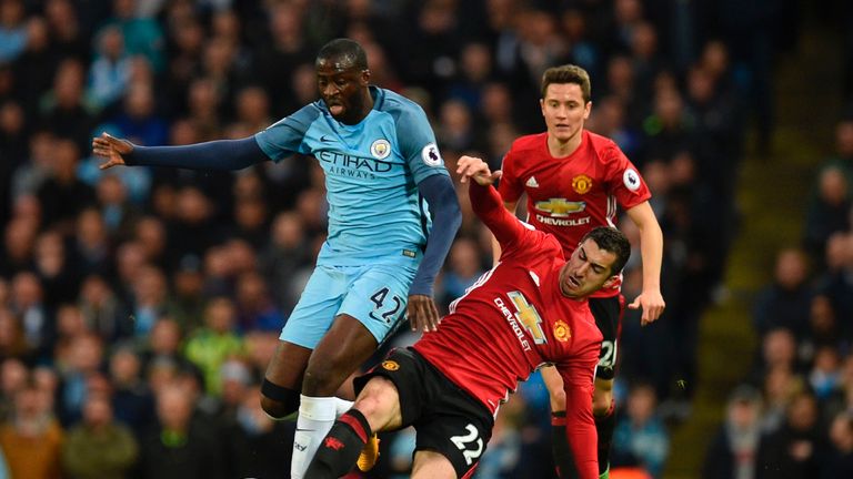 Yaya Toure (L) rides the challenge of Henrikh Mkhitaryan