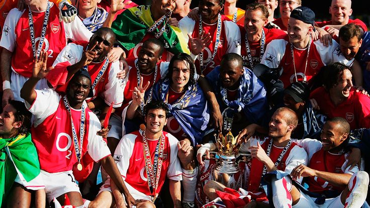 Arsenal players celebrate their unbeaten title triumph in 2003/04