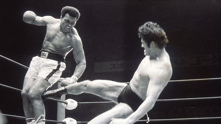 5 Jul 1976:  Muhammad Ali fends off a kick from wrestler Antonio Inoki during an exhibition fight in Tokyo, Japan. \ Mandatory Credit: Allsport Hulton/Arch