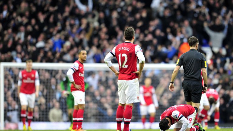 Arsenals players react after conceding the second goal during the Premier League football match between Tottenham and Arsenal at White Hart Lane in 2013