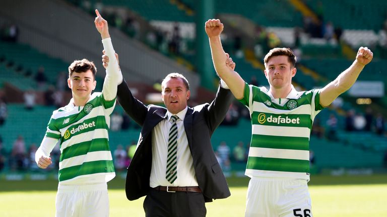 Brendan Rodgers celebrates with Michael Johnston and Anthony Ralston at full-time