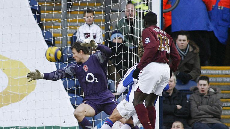 Blackburn Rover's Morten Gamst Pedersen (hidden) scores past Arsenal's Jens Lehmann (L) during their English Premiership match in 2006