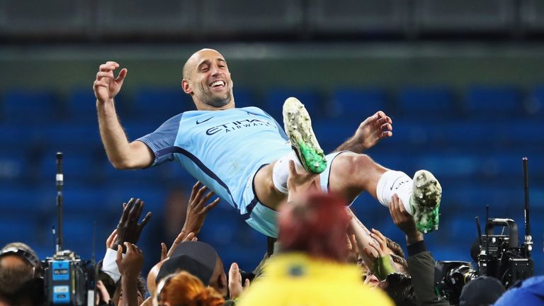 Zabaleta is thrown up in the air by his Manchester City team-mates