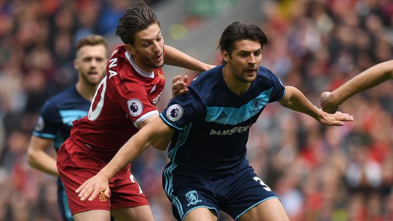 Liverpool's English midfielder Adam Lallana (L) vies with Middlesbrough's English defender George Friend during the English Premier League football match b