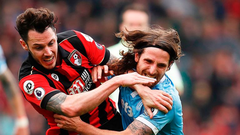 Adam Smith and Joe Allen tussle with each other at the Vitality Stadium