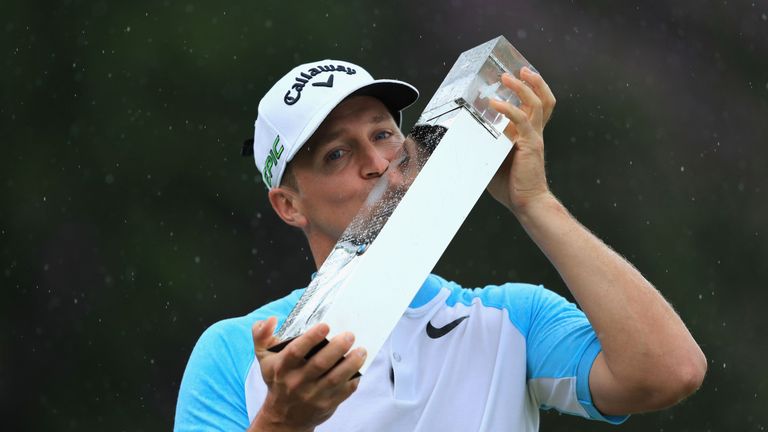 Alex Noren of Sweden kisses the trophy after winning the BMW PGA Championship at Wentworth 