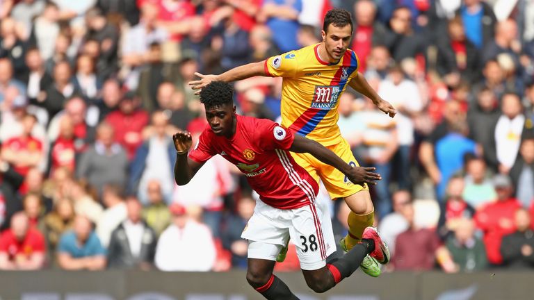 MANCHESTER, ENGLAND - MAY 21:  Axel Tuanzebe of Manchesater United and Luka Milivojevic of Crystal Palace in action during the Premier League match between