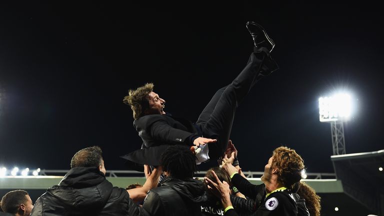 Antonio Conte is given the celebration bumps by his Chelsea players