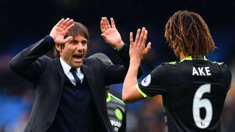 Chelsea's Italian head coach Antonio Conte (L), with Chelsea's Dutch defender Nathan Ake, celebrates victory at the end of the English Premier League footb