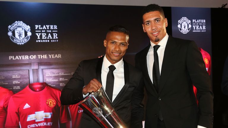 Antonio Valencia is presented with the Players' Player of the Year award by last year's winner Chris Smalling