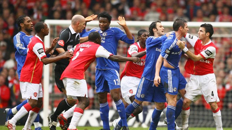 CARDIFF, UNITED KINGDOM - FEBRUARY 25:  Referee Howard Webb attempts to difuse a brawl between the  Arsenal and Chelsea players during the Carling Cup Fina