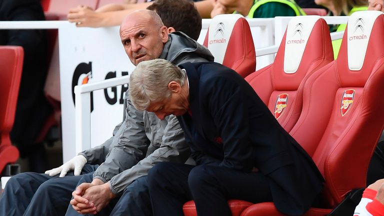 Arsene Wenger cuts a dejected figure in the dugout at the Emirates Stadium
