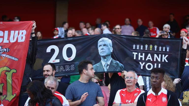 Fans display banners during the Premier League match between Arsenal and Everton at Emirates Stadium on May 21, 2017