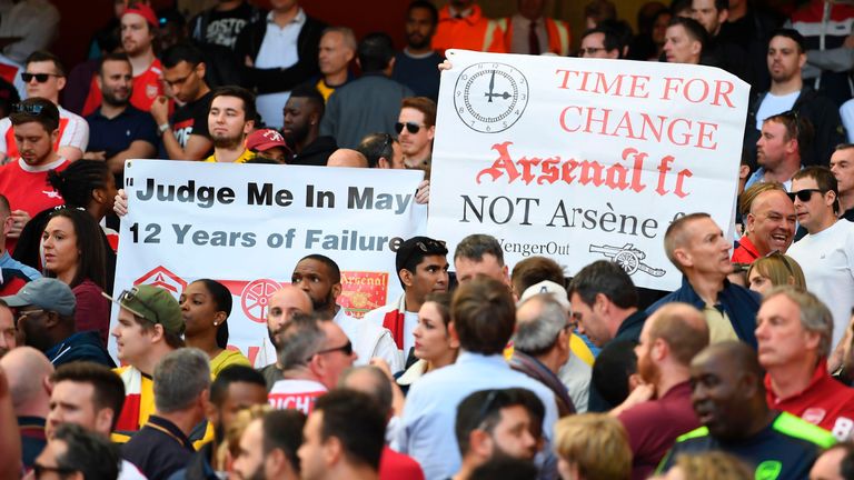 Fans hold up banners calling for a managerial change during the English Premier League football match between Arsenal and Everton at the Emirates Stadium