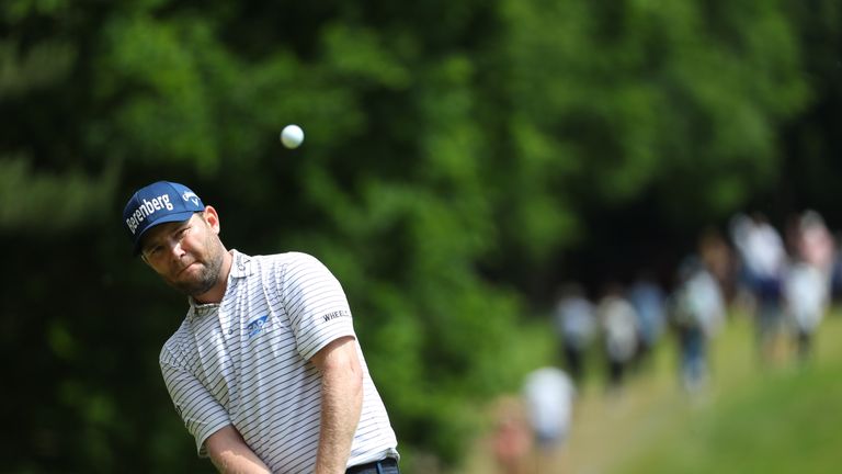 Branden Grace of South Africa chips onto the green during the final round on day four of the BMW PGA Championship at Wentworth