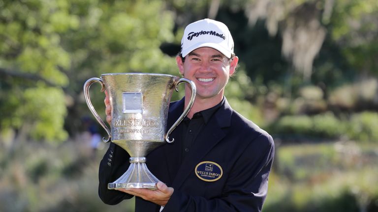 Brian Harman poses with the trophy after winning the Wells Fargo Championship at Eagle Point Golf Club