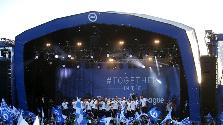 Brighton and Hove Albion players celebrate on stage during the parade.
