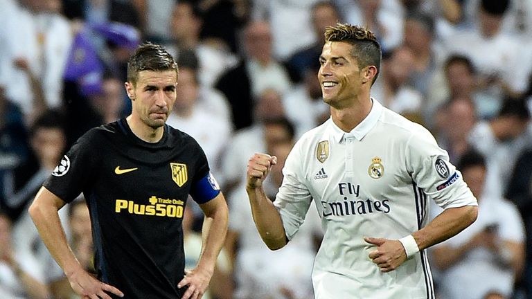 Gabi watches as Real Madrid's Cristiano Ronaldo celebrates after scoring his third goal during the UEFA Champions League semifinal first leg v Atletico