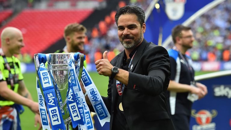 Huddersfield Town's German head coach David Wagner gestures as he holds the Championship Playoff trophy on the pitch after winning the penalty shoot-out in