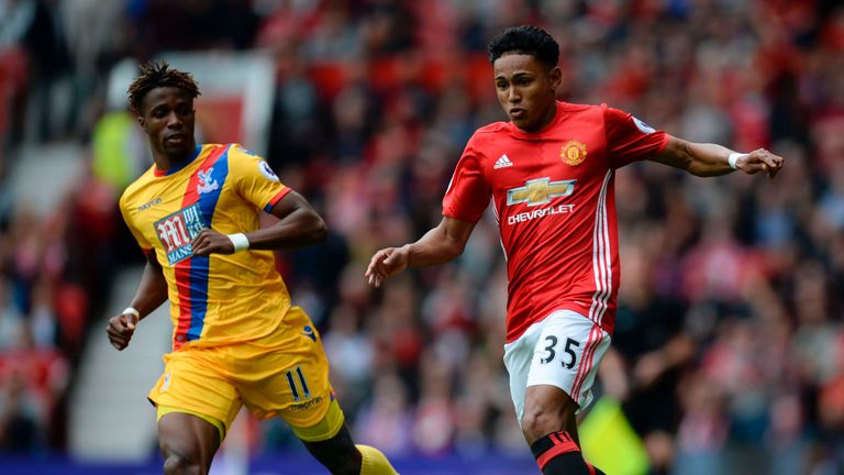 Manchester United's English defender Demetri Mitchell (R) battles with Crystal Palace's Ivorian striker Wilfried Zaha (L) during the English Premier League