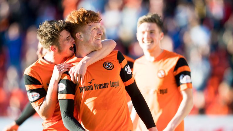 Dundee United's Simon Murray (centre) celebrates with teammate Jamie Robson.