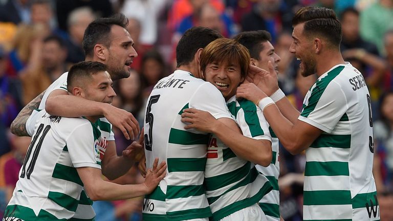 Eibar's Japanese midfielder Takashi Inui (C) celebrates with teammates after scoring a goal during the Spanish league football match FC Barcelona vs SD Eib