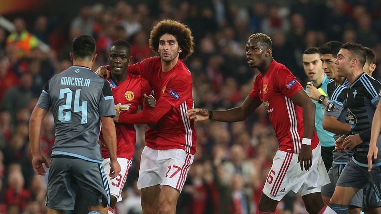 Eric Bailly is restrained by Marouane Fellaini