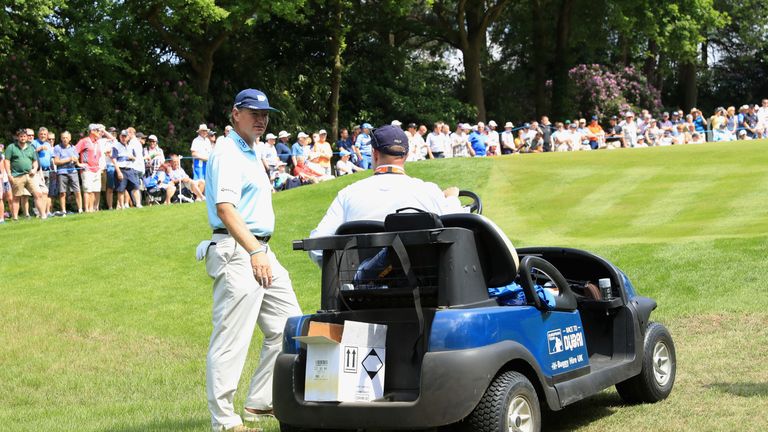 VIRGINIA WATER, ENGLAND - MAY 25:  Ernie Els of South Africa talks to rules official Simon Higginbottom on the 14th hole during day one of the BMW PGA Cham