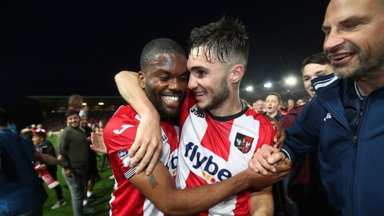 Exeter City's Jordan Moore-Taylor (right) and Joel Grant celebrate after the final whistle during the Sky Bet League Two play-off second leg at St James Pa
