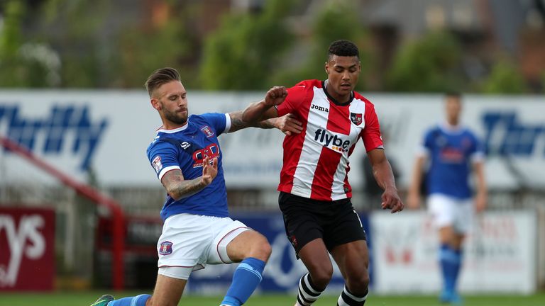 Exeter City's Ollie Watkins (right) and Carlisle United's James Bailey battle for the ball during the Sky Bet League Two play-off second leg at St James Pa