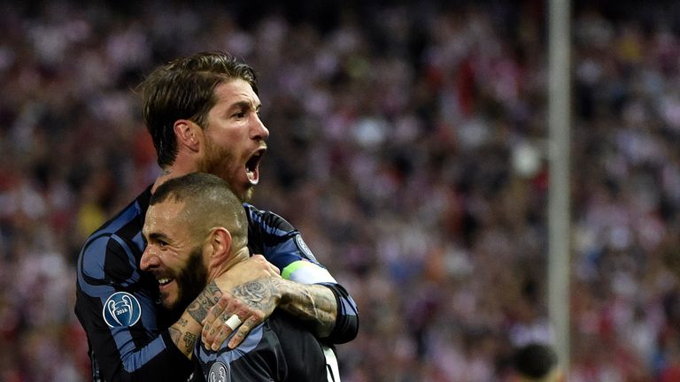 Real Madrid's French forward Karim Benzema (bottom) and Real Madrid's defender Sergio Ramos celebrate their opening goal during the UEFA Champions League s