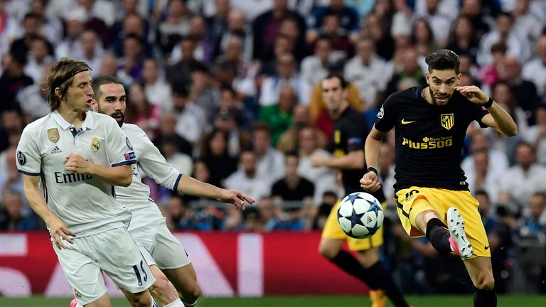 Atletico Madrid's Yannick Ferreira Carrasco (R) vies with Real Madrid's Luka Modric (L) and Dani Carvajal, Champions League