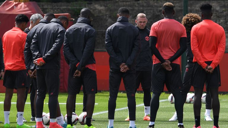 Manchester United's Wayne Rooney stands with team-mates as they observe a minute's silence for the victims of Monday's terror attack