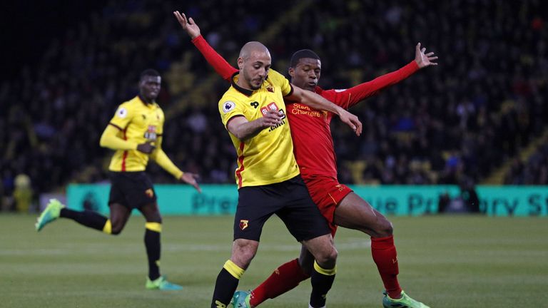 Watford midfielder Nordin Amrabat is challenged by Liverpool's Georginio Wijnaldum