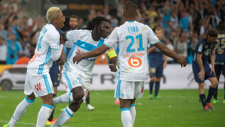 Olympique de Marseille's French forward Bafetimbi Gomis (C) is congratulated by Cameroonian forward Clinton Njie (L) after scoring during the French L1 foo