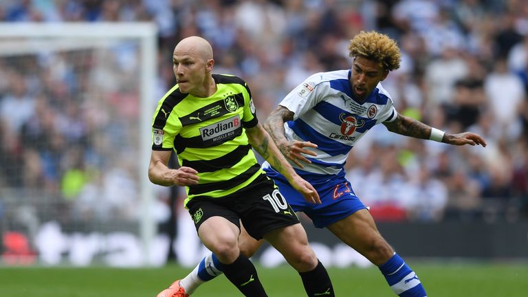 Aaron Mooy of Huddersfield Town attempts to get away Reading's Daniel Williams