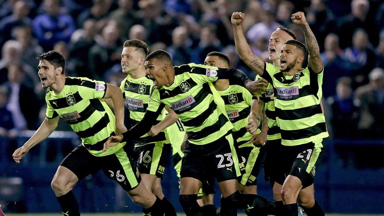 The Huddersfield Town team celebrate after Danny Ward (not pictured) saves the final penalty to send them through v Sheffield Wednesday