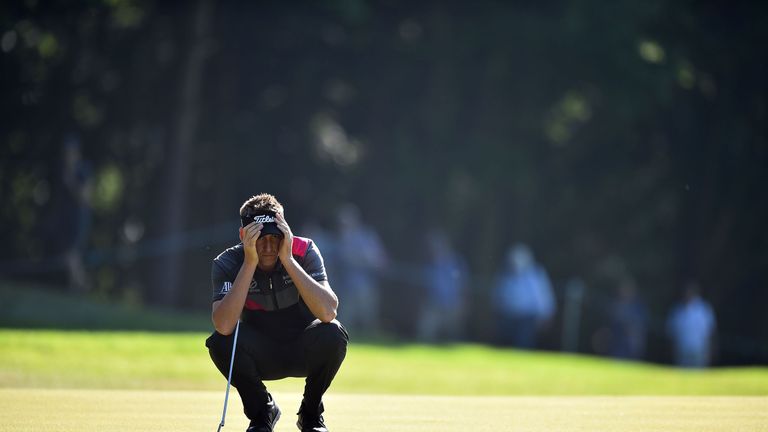 English golfer Ian Poulter lines up his putt on the first green on the second day of the golf PGA Championship at Wentworth Golf Club in Surrey, south west