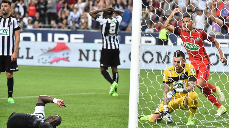 Angers' French defender Issa Cissokho (L) falls as Angers' French goalkeeper Alexandre Letellier (C) and Paris Saint-Germain's Brazilian defender Marquinho