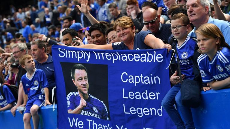 A fan holds up a John Terry bannerahead of  match between Chelsea and Sunderland at Stamford Bridge in London on May 21, 2017