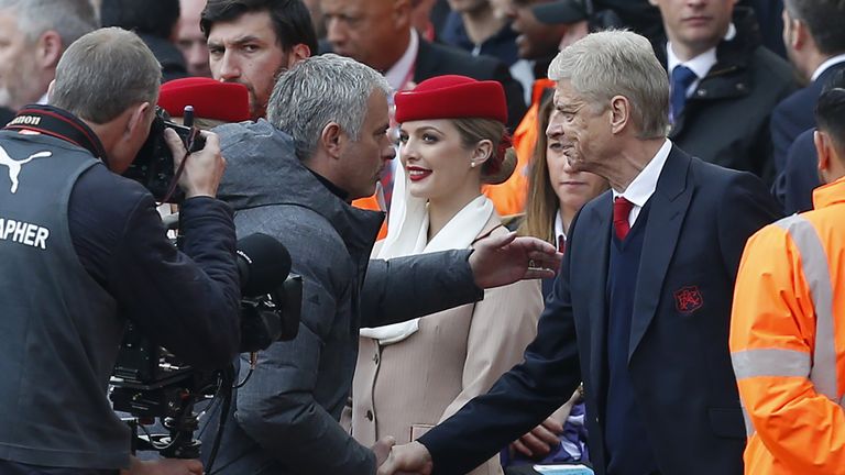 Arsenal's French manager Arsene Wenger (R) shakes hands with Manchester United's Portuguese manager Jose Mourinho ahead of the English Premier League footb