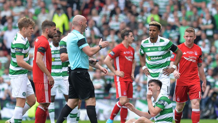 Kieran Tierney sits on the turf with a facial injury that forced him to be substituted in the first half