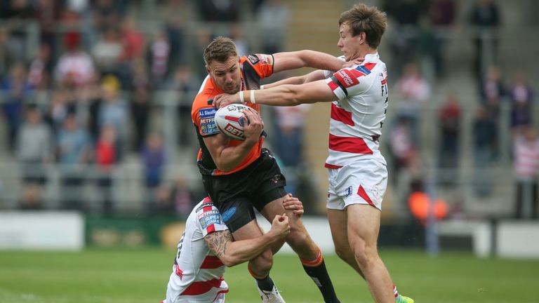 Michael Shenton of Castleford Tigers is tackled by Matthew Flemming of Leigh Centurions and Ben Reynolds 