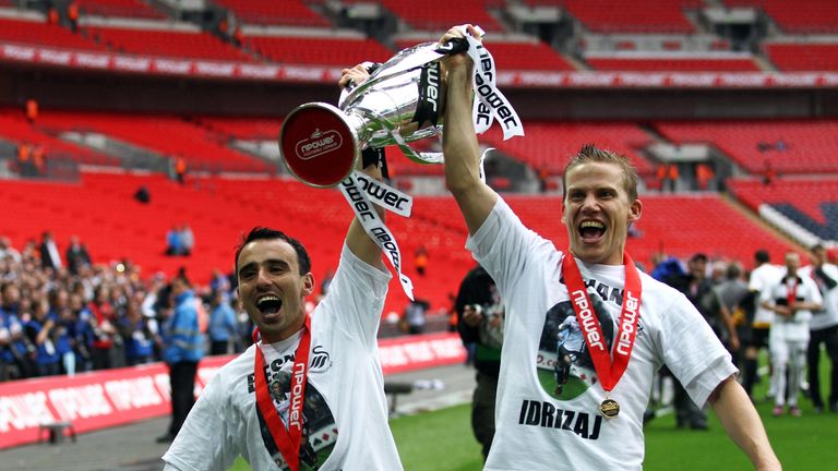 LONDON, ENGLAND - MAY 30:  Leon Britton (L) and Mark Gower of Swansea celebrates with the trophy after winning the npower Championship Playoff Final betwee