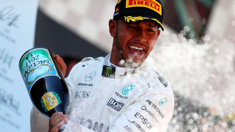 MONTMELO, SPAIN - MAY 14:  Race winner Lewis Hamilton of Great Britain and Mercedes GP celebrates his win on the podium during the Spanish Formula One Gran