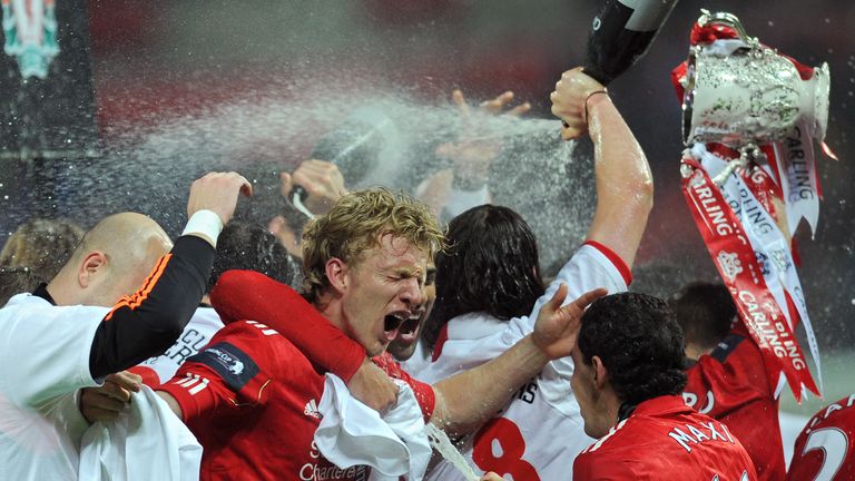 Liverpool's Dutch footballer Dirk Kuyt (2nd L) is doused in champagne as his team celebrate beating Cardiff City in a penalty shoot out in the League Cup F
