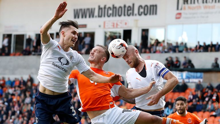 Luton Town's Scott Cuthbert (right) battles for the ball with Blackpool's Tom Aldredl with Dan Potts (left), during the Sky Bet League Two Play Off, First 