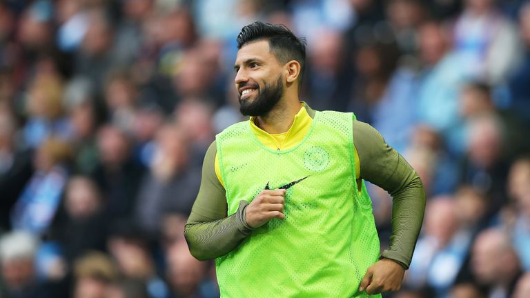 Sergio Aguero warms up on the sidelines during the match against Leicester City