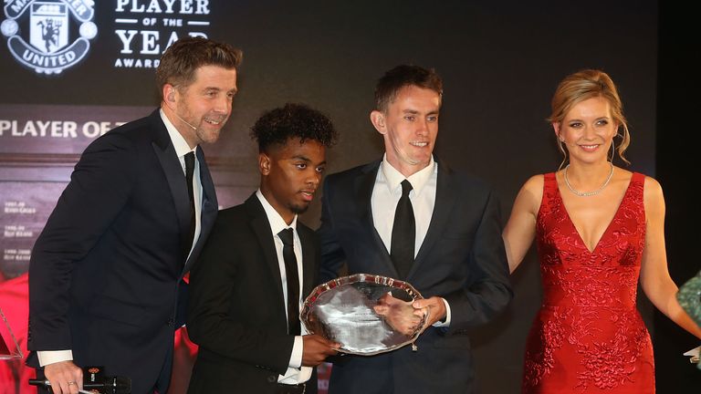 Angel Gomes of Manchester United is presented with the Jimmy Murphy Under-18s Player of the Year award by U18s manager Kieran McKenna
