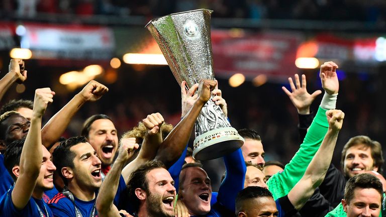 TOPSHOT - Manchester United's players celebrate with the trophy after winning the UEFA Europa League final football match Ajax Amsterdam v Manchester Unite